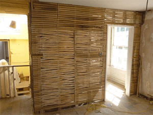 this photo clearly shows where the diagonal support has been cut in order to install a new doorway.